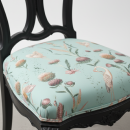 detalle de tapizado de silla antigua con estampado de flores y garzas